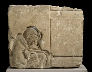 Limestone Fragment Carved in Sunken Relief Depicting a Sleepy Servant in the Palace